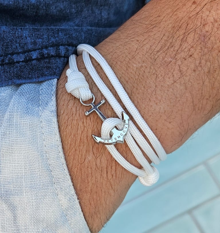 a man's armbands with a anchor on it