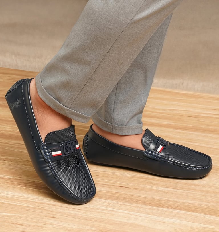 a person wearing a pair of shoes with a red, white and blue stripe