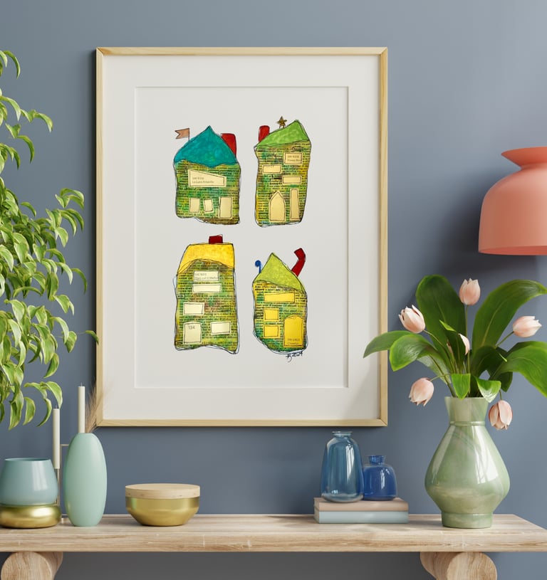 a picture of four whimiscal houses and a vase with flowers along with vases on a table