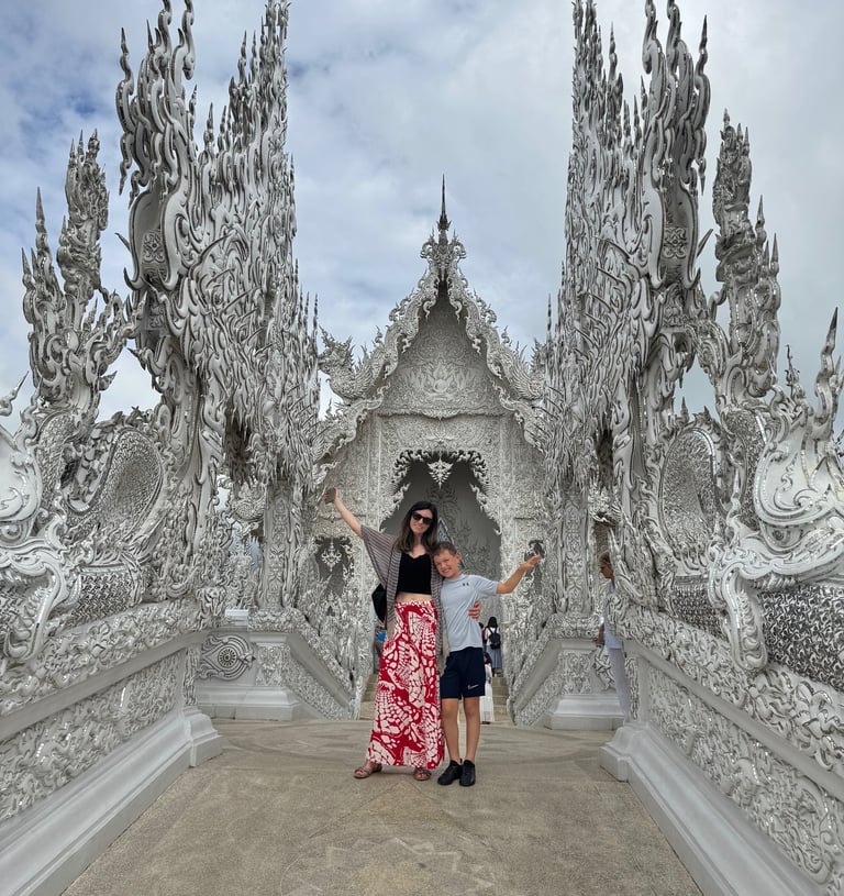white temple in chaing rai thailand with families