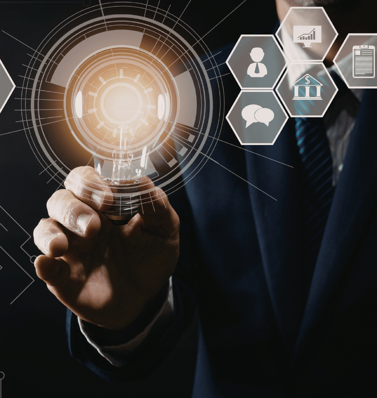 Businessman holding a glowing lightbulb with digital technology icons for business innovation and creative solutions.