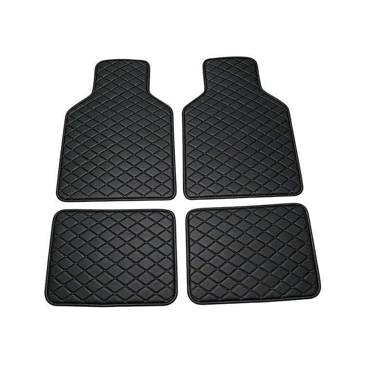 A set of four black diamond-stitched leather car floor mats for vehicle interior protection.