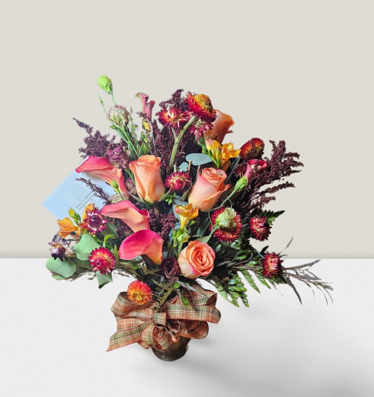 a bouquet of flowers in a vase on a table