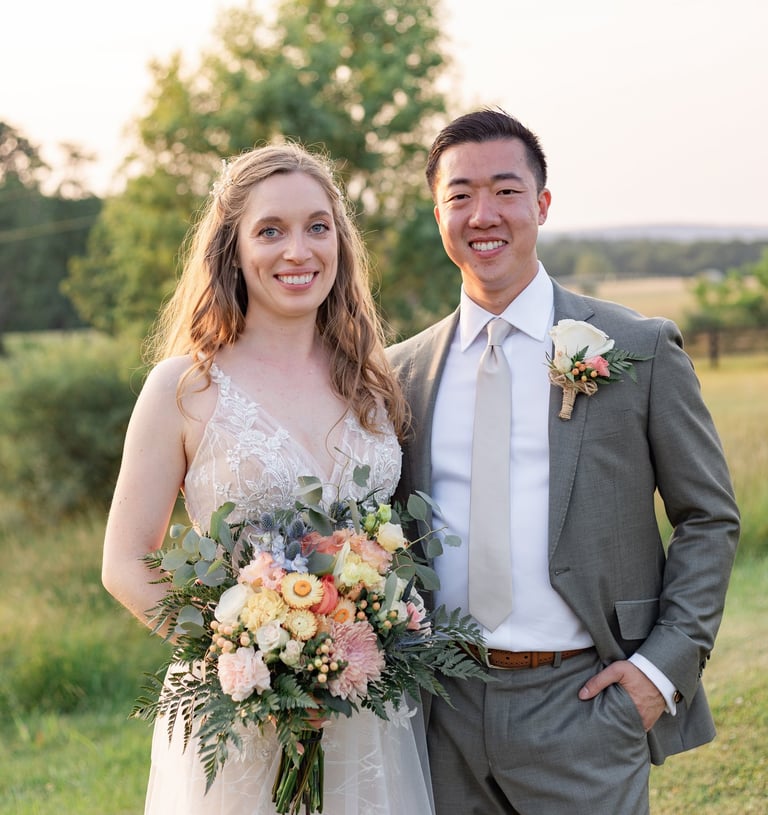 a man and woman standing in a field