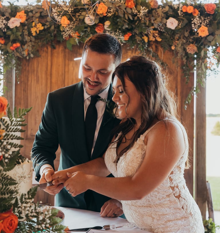 a bride and groom cutting their wedding cake
