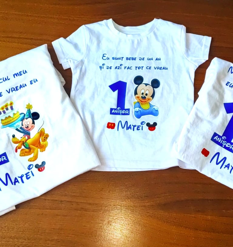 a group of three shirts with mickey mouse shirts