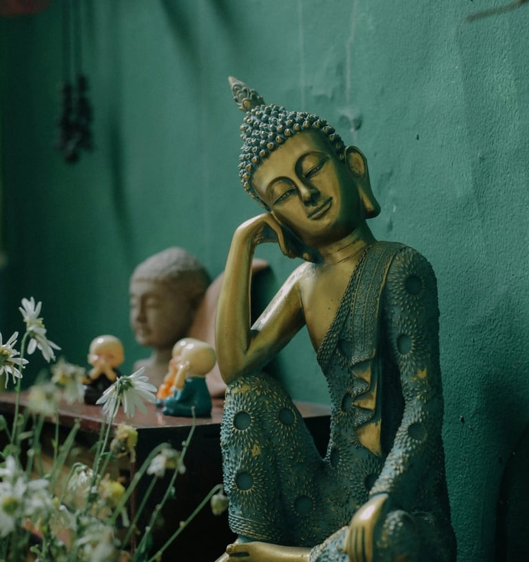 Buddha statue against green background symbolizing mindful breathing, everyday essentials