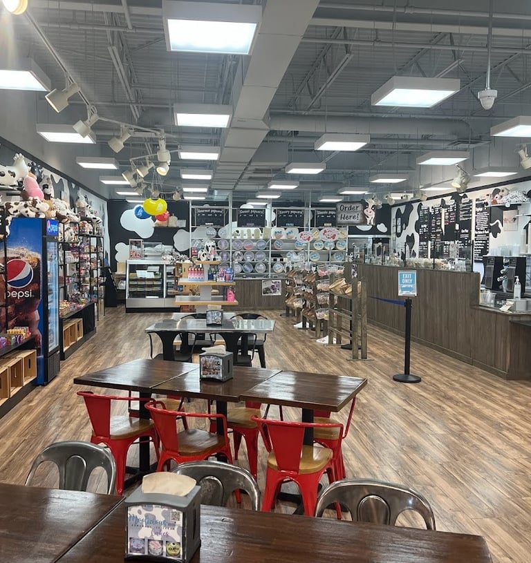 a store with tables and chairs and a wooden table