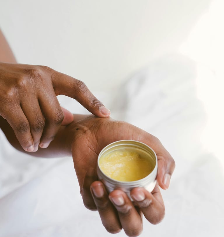 a person holding a box of body cream in their hands
