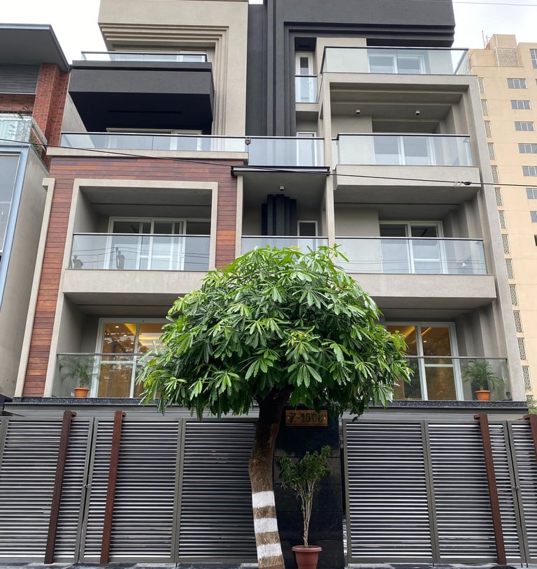 a tree in front of a tall building