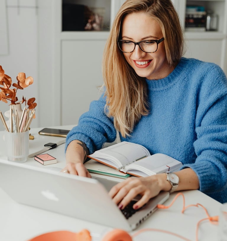 a woman sitting at a table with a book and a book