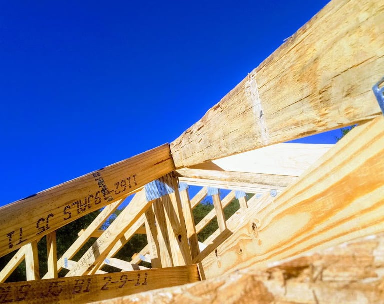 a wooden frame roof with a wooden roof and a metal roof