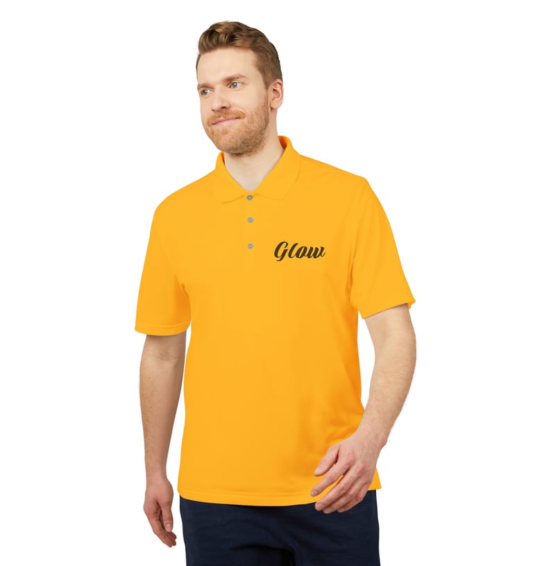 A man wearing a vibrant yellow polo shirt with a black Glow logo on the chest.