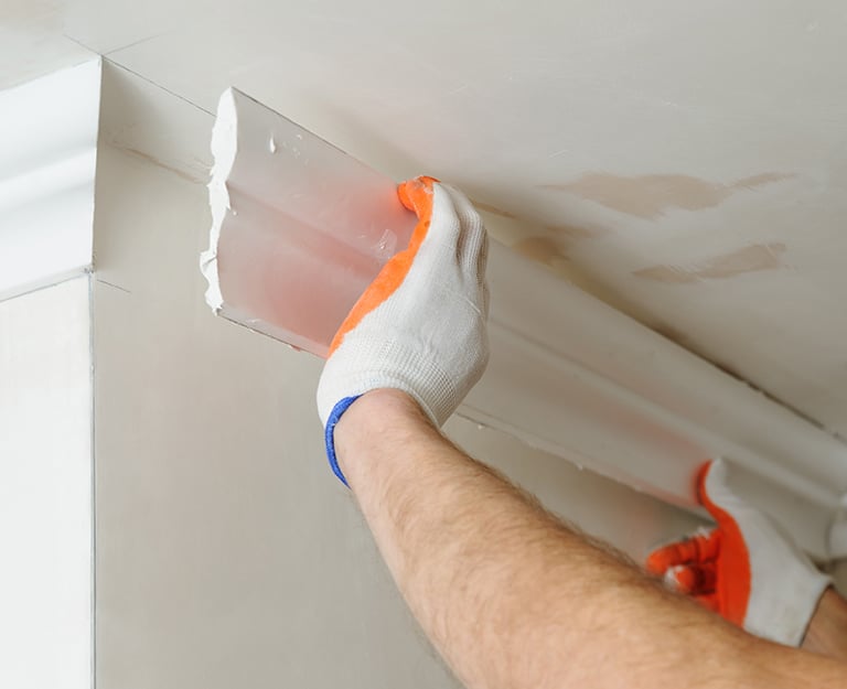 a man is painting a ceiling with a paint job