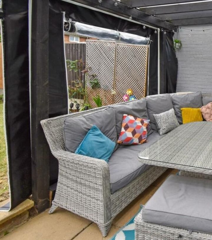 PVCFAB Aluminium pergola with heavy duty roll up all weather PVC covers and curtains in black