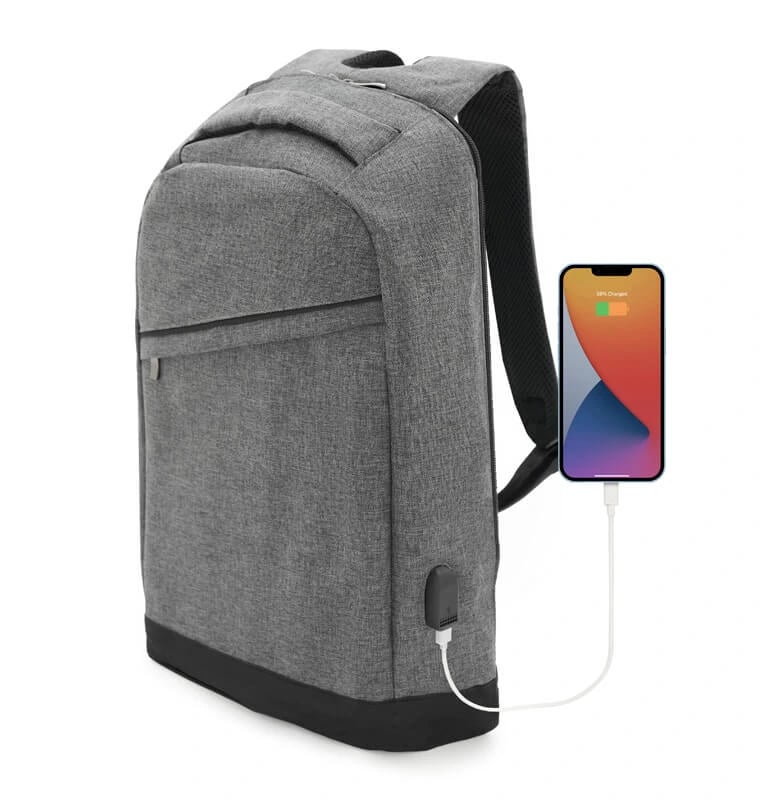 Grey anti-theft laptop backpack with a built-in USB charging port connected to a smartphone.