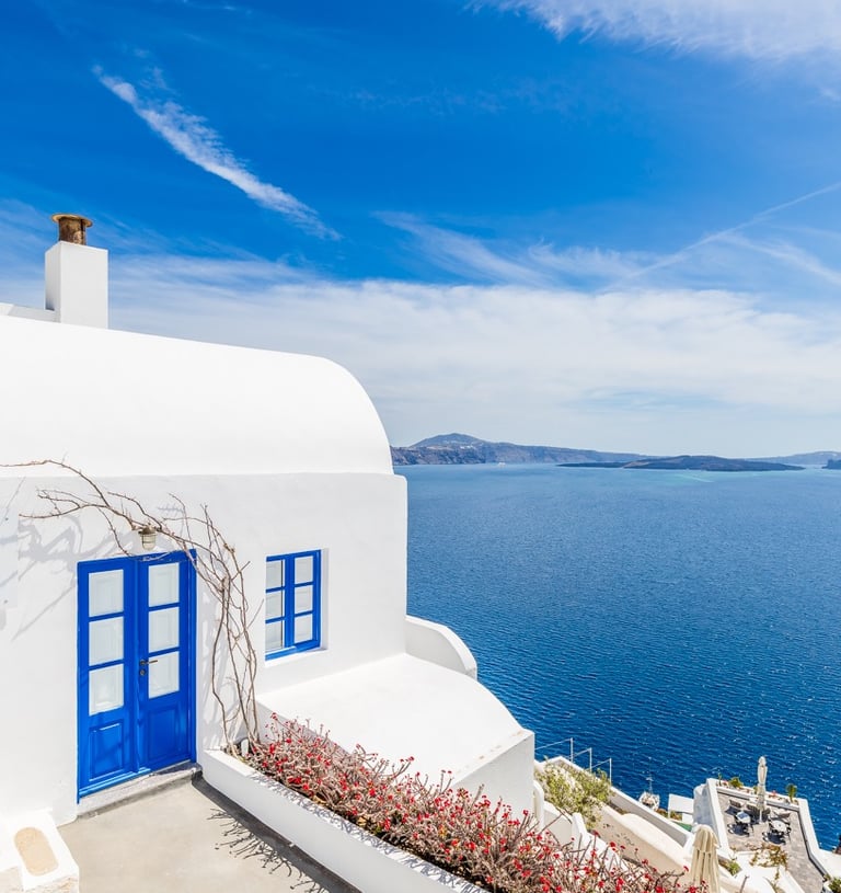 Santorin a house with a blue door and a blue sky