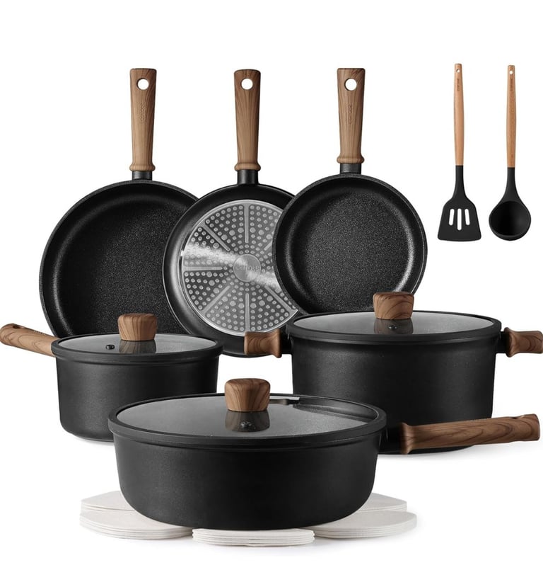 a group of pots and pans with a variety of cooking utensils