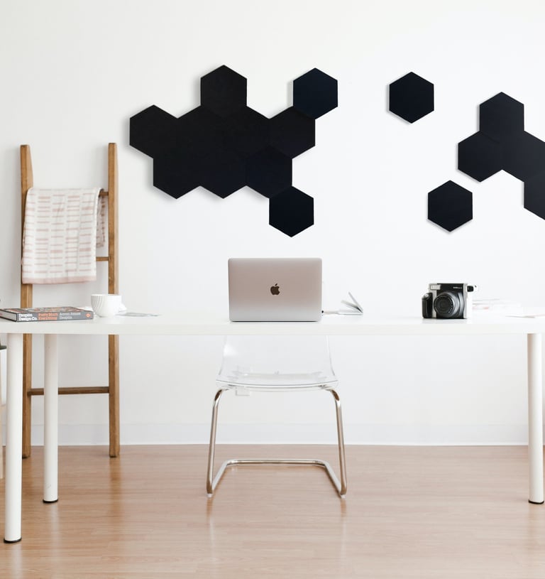 a desk with a laptop and a laptop on a table