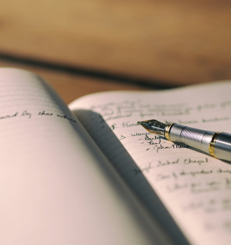 Fountain pen on a journal by Aaron Burden