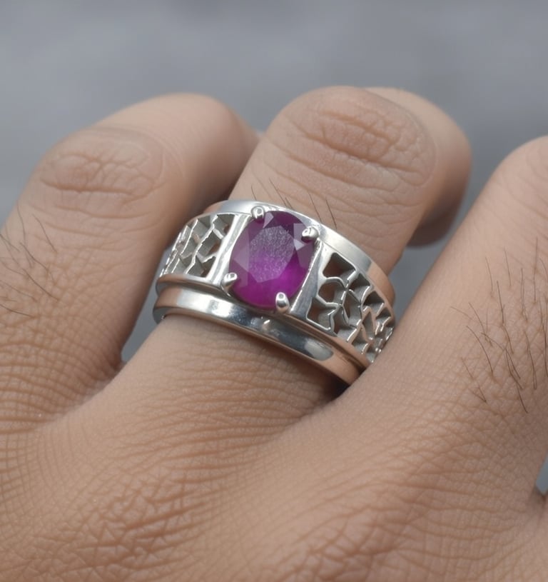 Elegant men's silver ring featuring an oval-cut purple ruby gemstone and intricate filigree design.