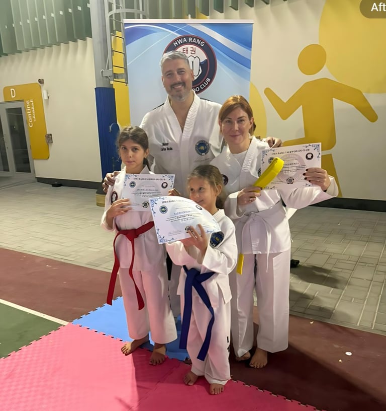Master Carlos Bazan, 7th Dan & World Champion presenting new belts to family at a taekwondo Exam