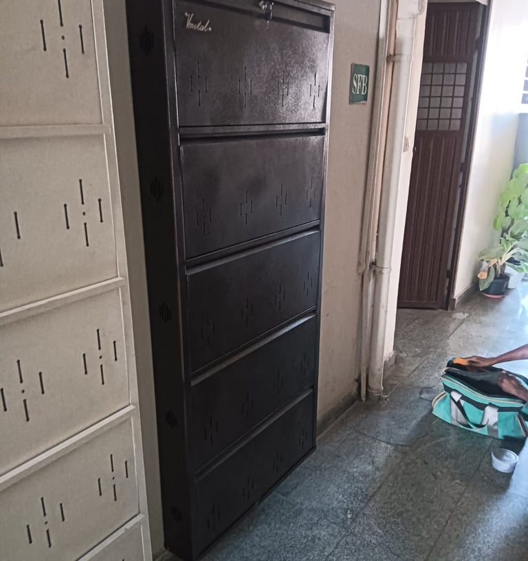 metal shoe rack cabinets with five compartments in a hallway