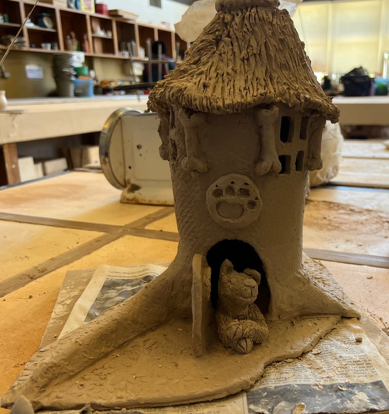 A work-in-progress view of the ceramic base for 'The Barking Spire,' showing the hand-sculpted clay 