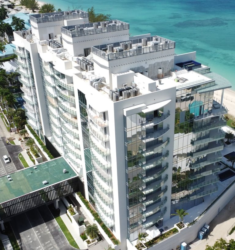 Luxury residential high-rise—The Watermark, Cayman, viewed from the beach with modern architect