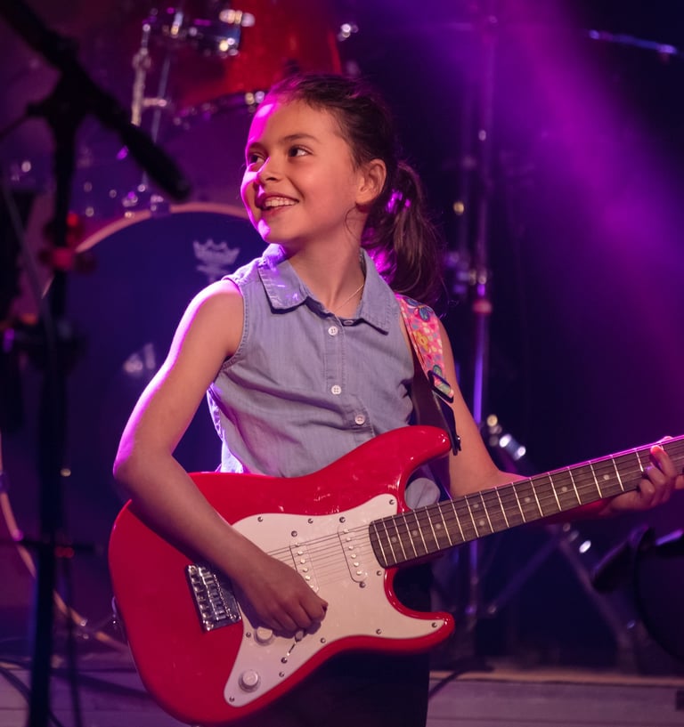 Gurnee Guitar Academy Guitar Lessons a girl with a guitar and a guitar
