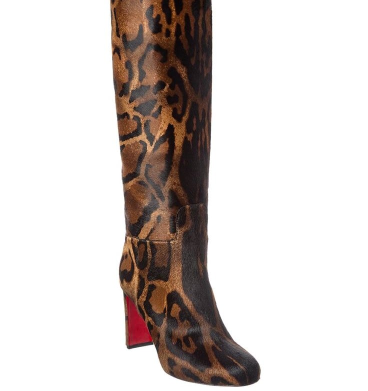 a woman's Christian Louboutin leopard print boots with a leopard print