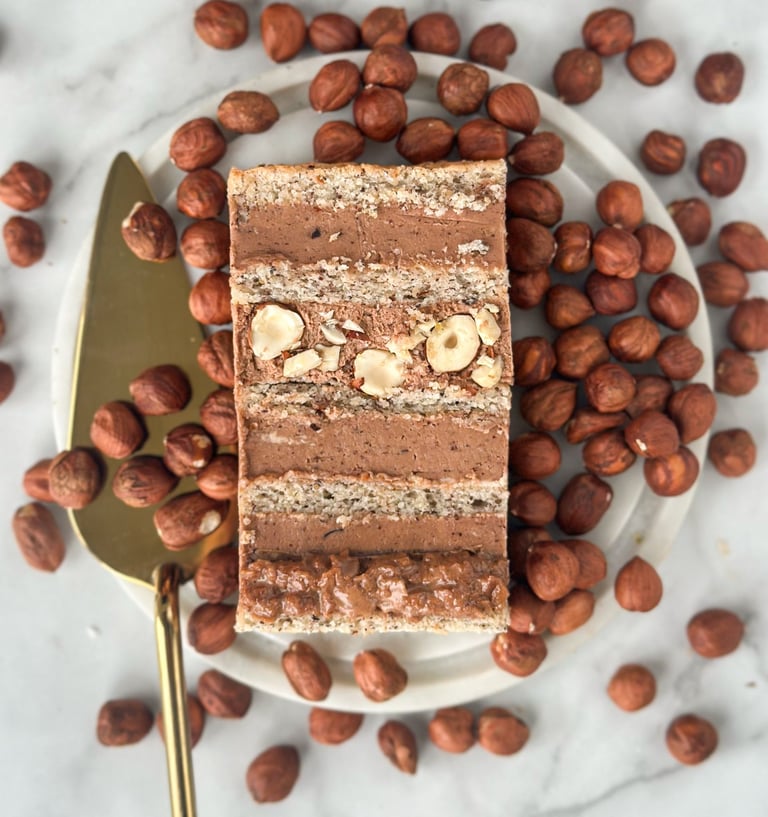 a piece of cake with nuts and nuts on a plate