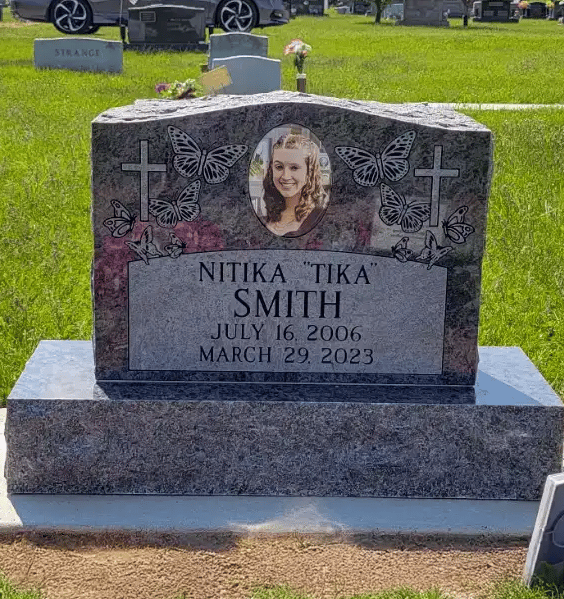 single upright tombstone in bahama blue granite with porcelain memorial portrait
