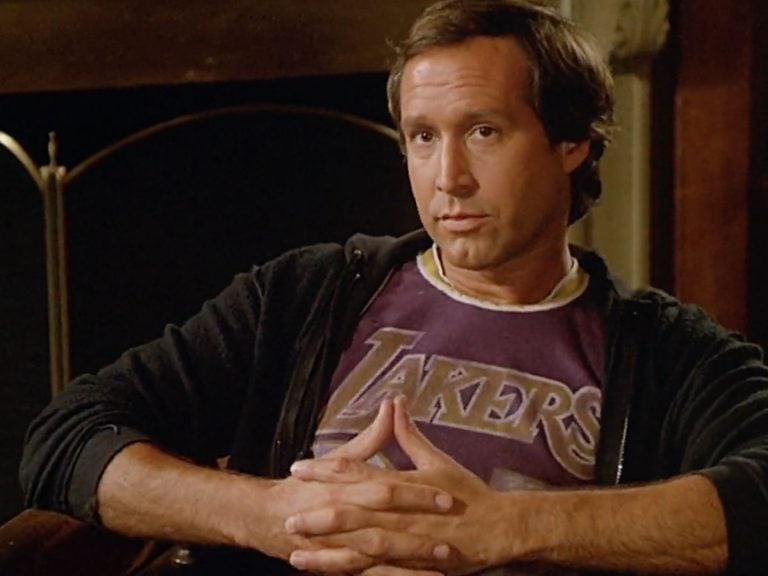 a man in a purple shirt and a black jacket