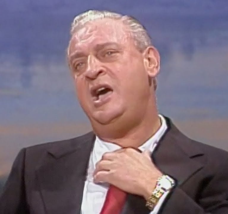 a man in a suit and tie with a red tie