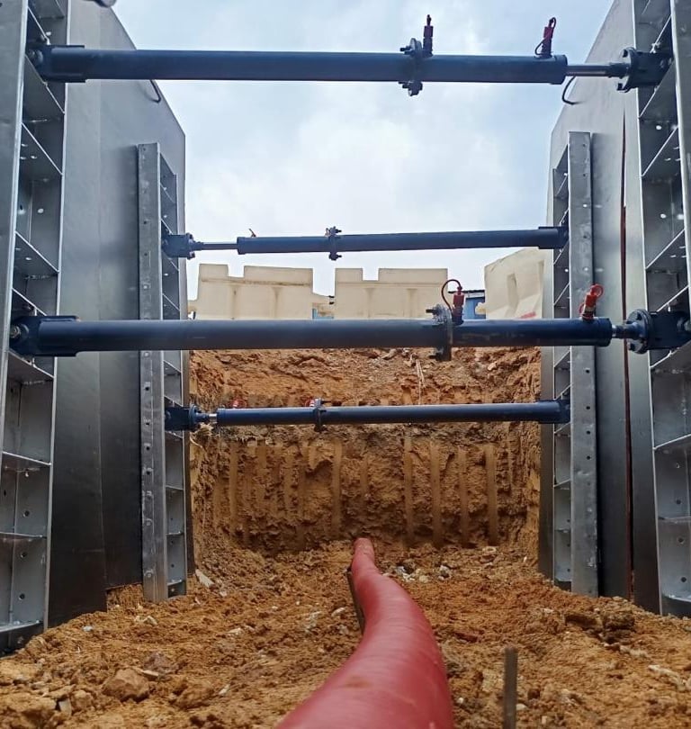 XpressJack quick shoring system supporting a trench during pipe and cable laying installation.