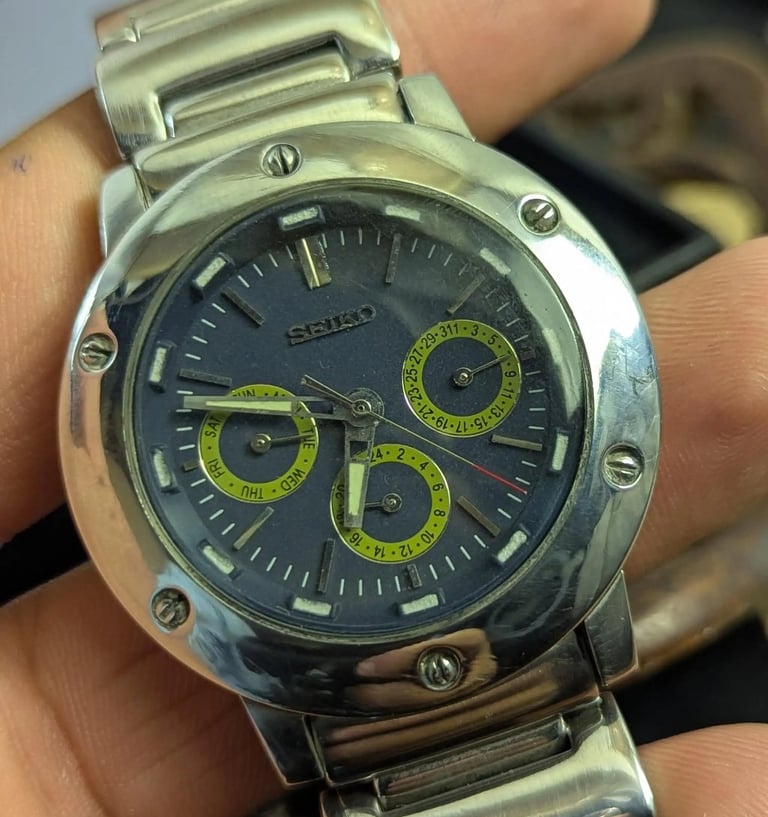 Seiko Blu dail Watch with Day date and second the persson holding it on  hand