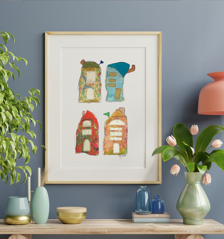 a picture of four whimiscal houses and a vase with flowers along with vases on a table