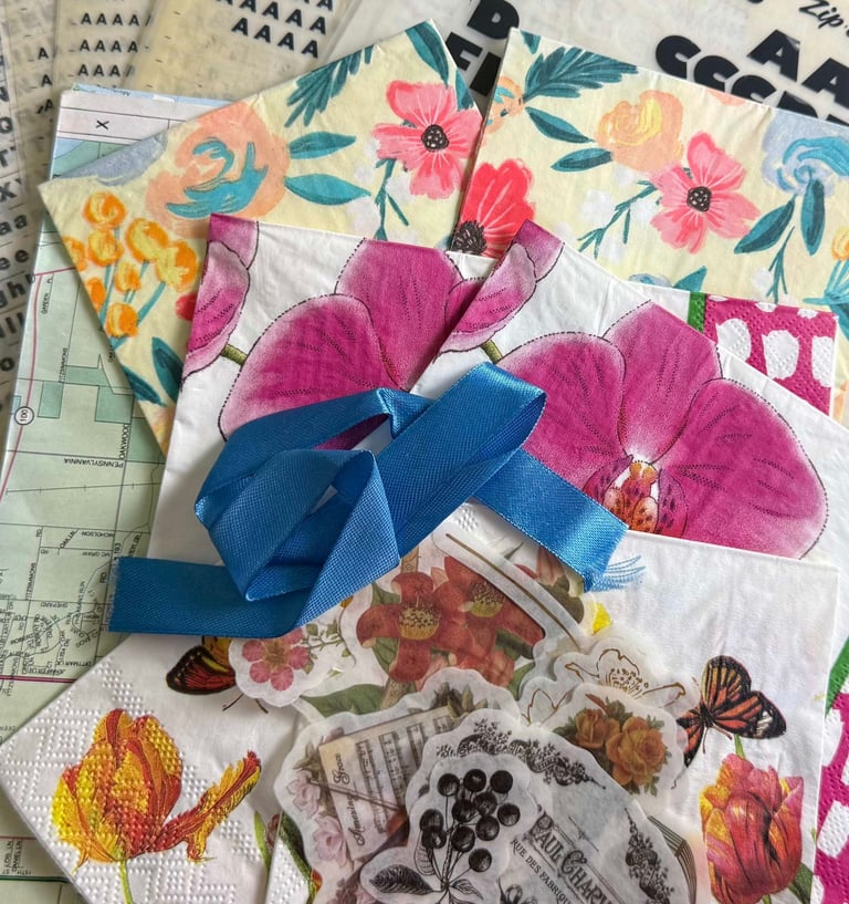 A collection of papers, napkins, transfers, letters, and ribbon