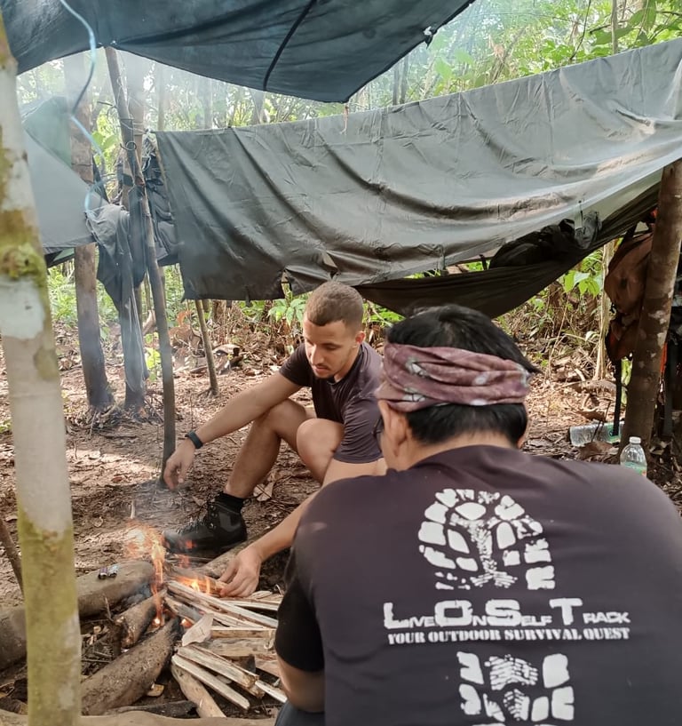 a guide and a traveller sitting around a campfire