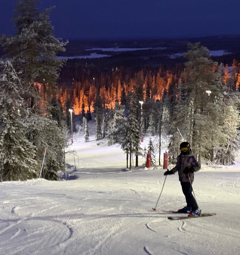 kids skiing in flood lit snow in ruka finland