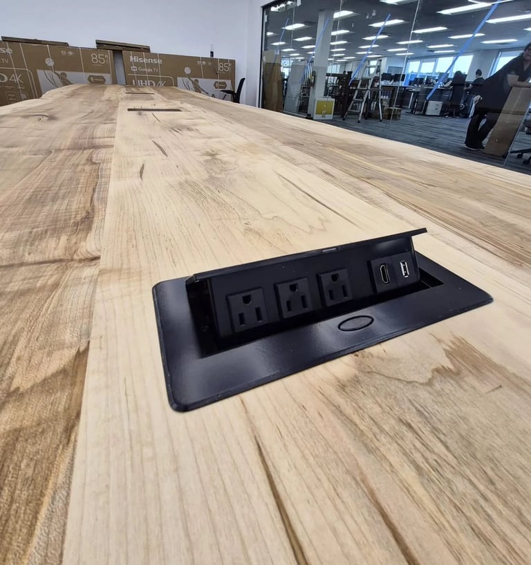 Integrated flush-mount power port in custom boardroom table — AC outlet, USB-A and USB-C