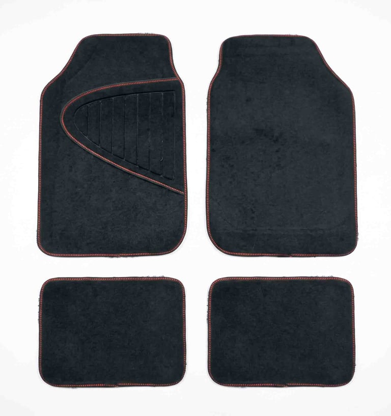 A set of four black carpet car floor mats with red stitching for vehicle interior protection.