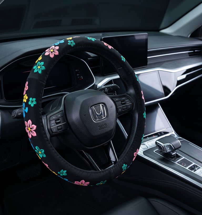 Black steering wheel with a colorful floral embroidered cover inside a modern Honda car interior.