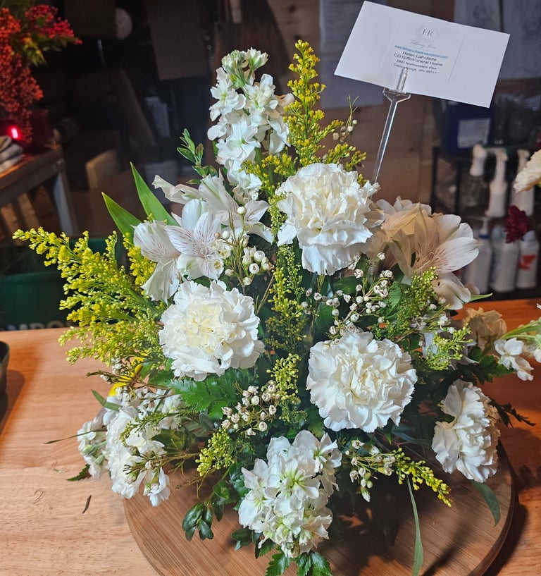 a vase with flowers on a wooden table