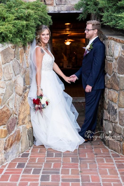 a bride and groom holding hands and holding hands