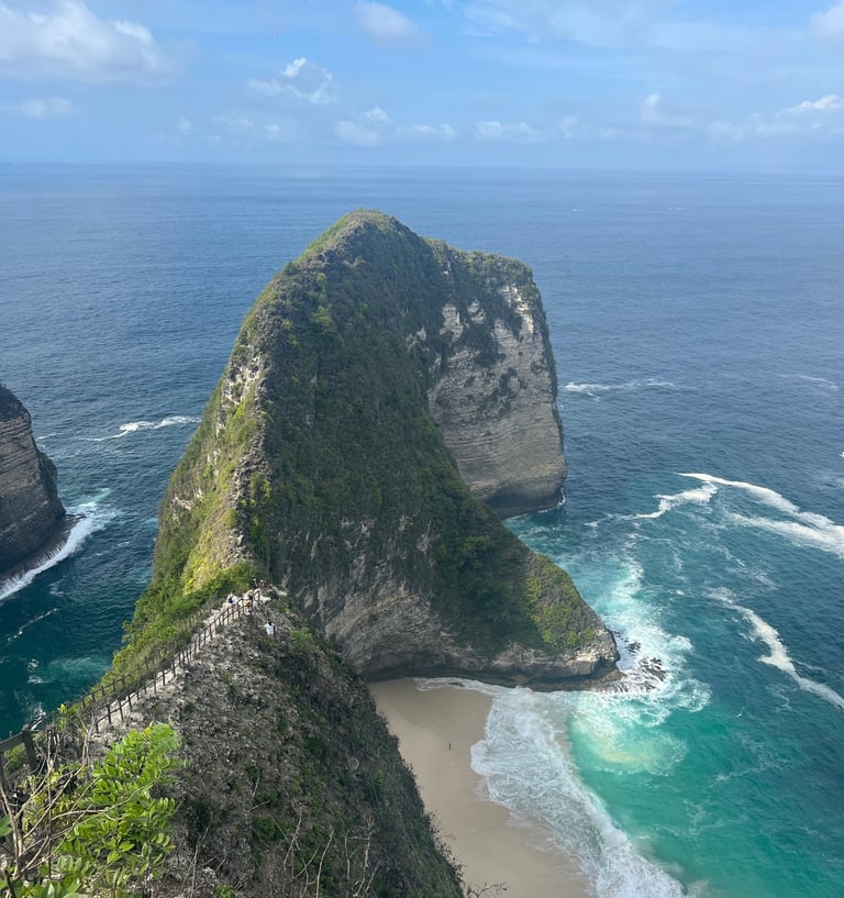 a person standing on a cliff overlooking a body of water