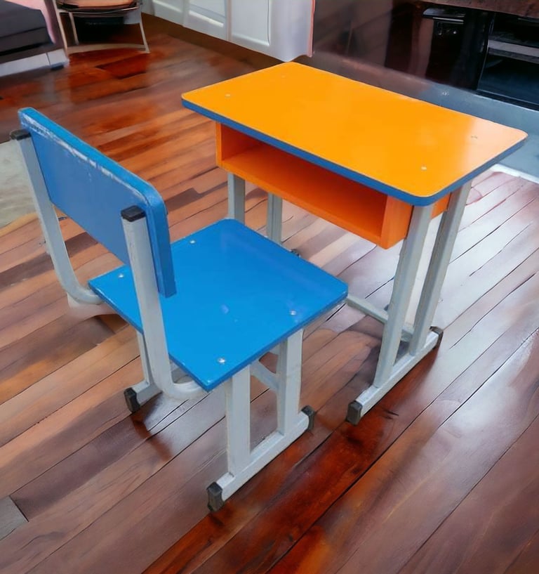 A colorful blue and orange student desk and chair set on a polished hardwood floor.