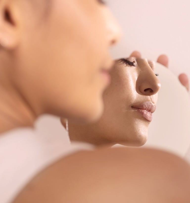 skin care. a woman is looking at her face in the mirror  - click shop button bottom middle of image