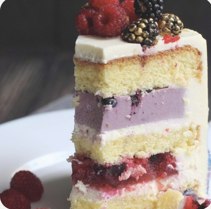 a piece of cake with berries on top of it